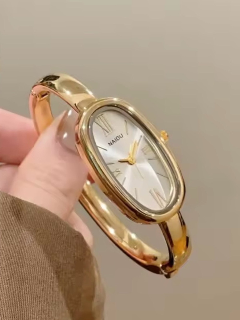 Kohl's NAIDU Gold Toned Bangle Watch with Oval Silver Dial